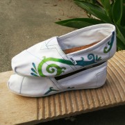 Custom, hand painted Color Swirl TOMS shoes featuring a green to blue ombre of a swirl design outlined in silver.