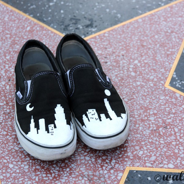 Custom, hand painted LA Cityscape Vans shoes featuring building silhouettes visible in the Los Angeles Skyline. Displayed at the Hall of Fame walk of stars in Hollywood.
