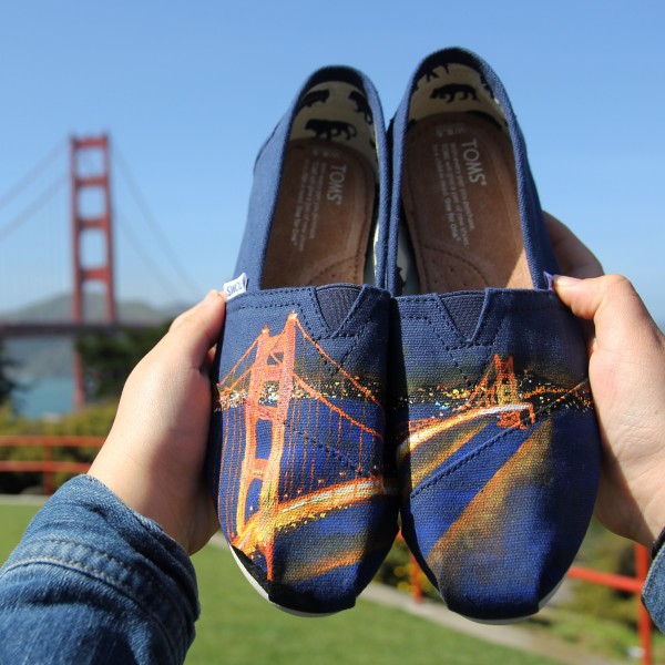 Custom, hand painted Golden Gate Bridge TOMS featuring the Golden Gate Bridge in San Francisco, California at night. Displayed in front of the actual Golden Gate Bridge in SF, CA.
