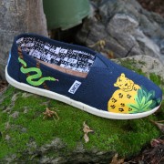 Custom, hand painted Rainforest youth TOMS shoes featuring a jaguar and snake in a tropical rainforest.